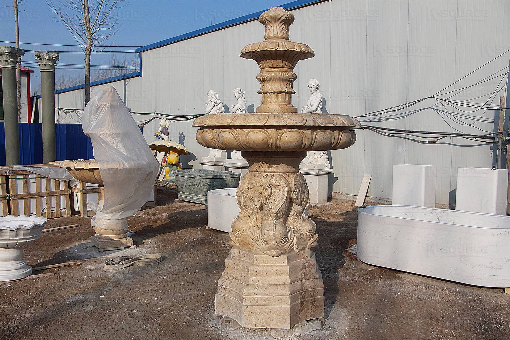 yellow stone fountain with pool and fish