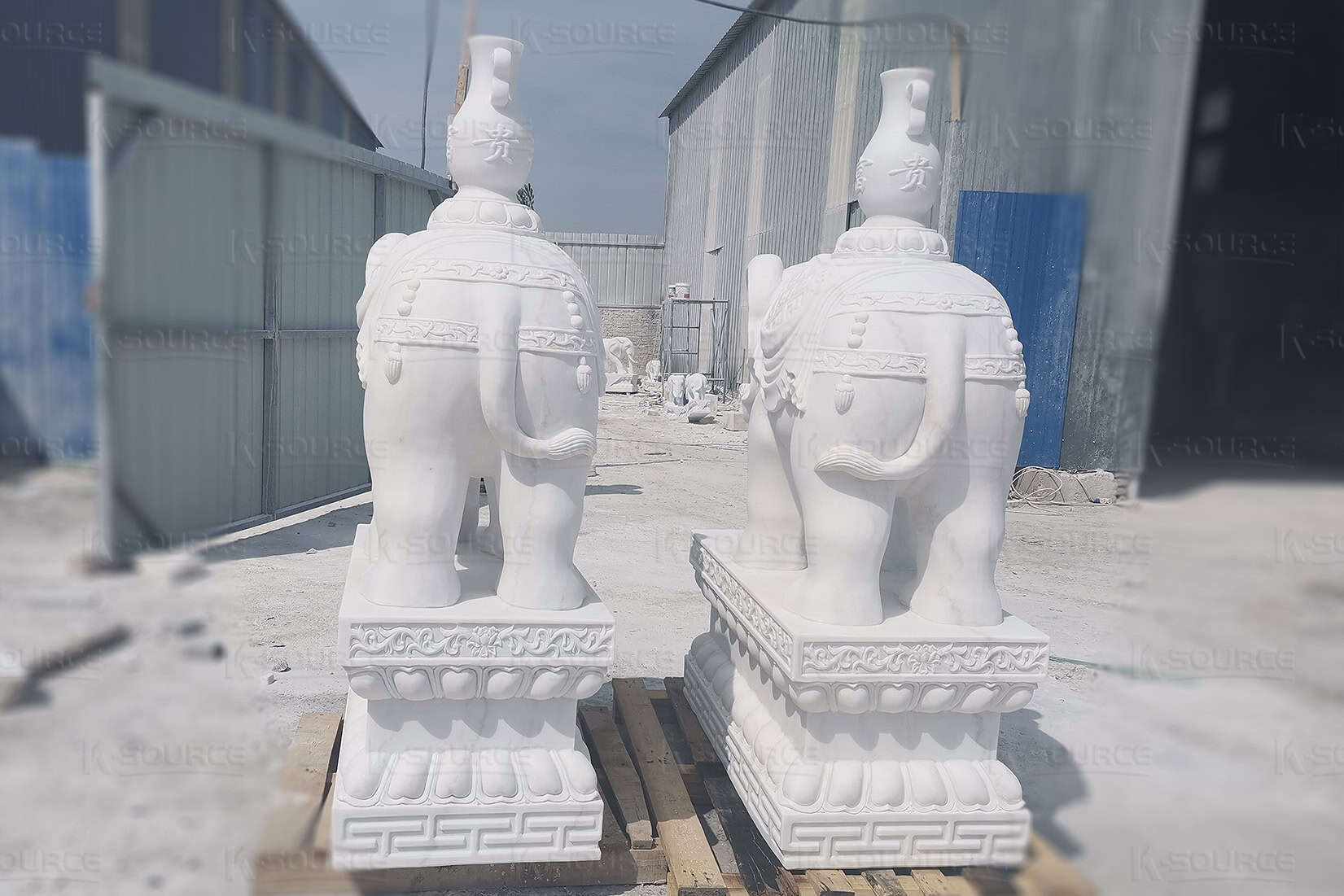 Marble elephant statue carrying a vase on its back