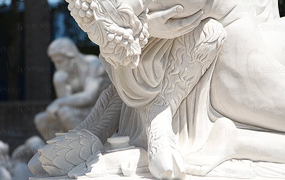 The statue is a half-human, half-animal male holding a human female nude.