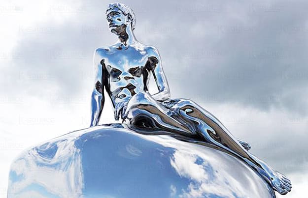 boy on stone stainless steel sculpture