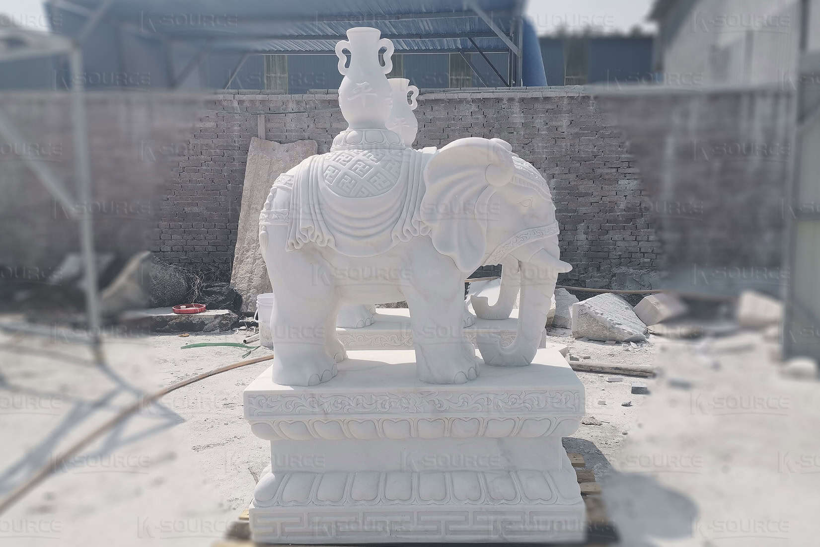 White elephant statue carrying a vase