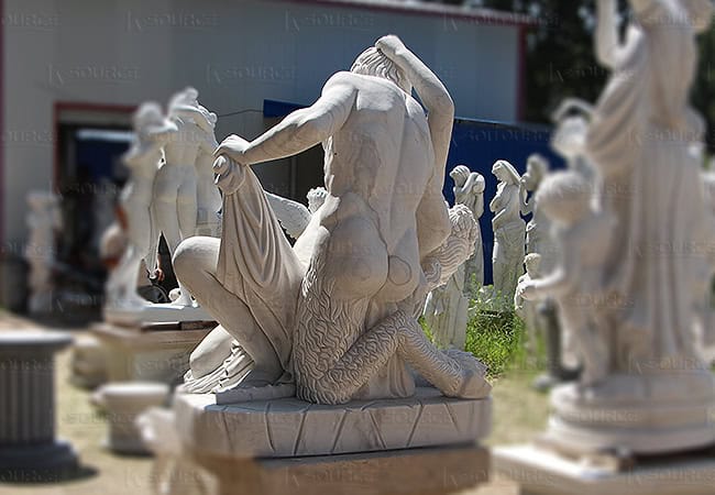 Marble statue of a naked half-man, half-animal man holding a naked woman.