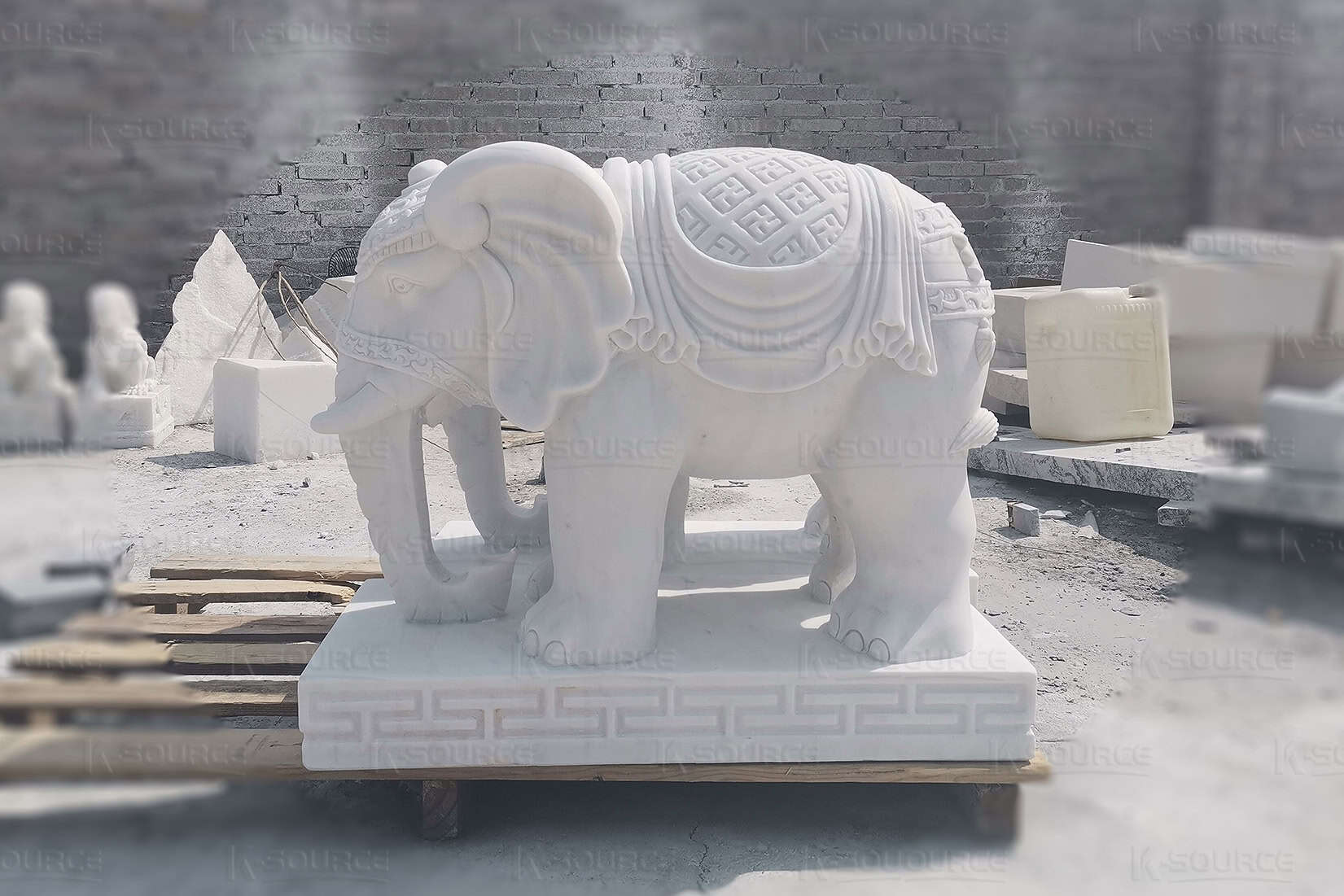 Two round white elephant stone sculptures