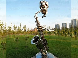 The long structure of the saxophone connects the incomplete player’s head and hands.