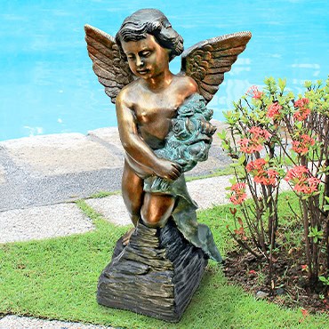 Bronze statue of a male angel of remembrance in the garden
