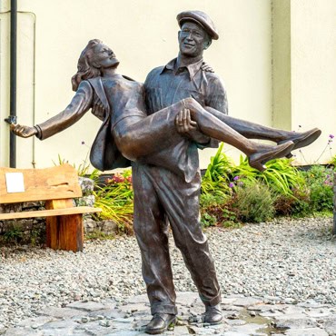 bronze statue of John Wayne and Maureen O